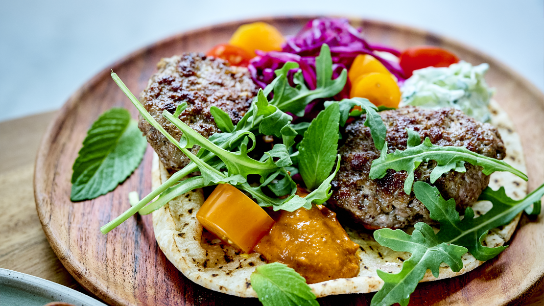 Spicy lamb burgers, harissa, tzatziki and grilled pita bread