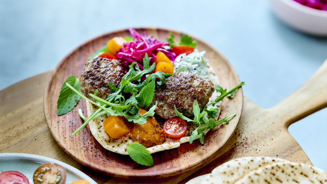 Spicy lamb burgers, harissa, tzatziki and grilled pita bread